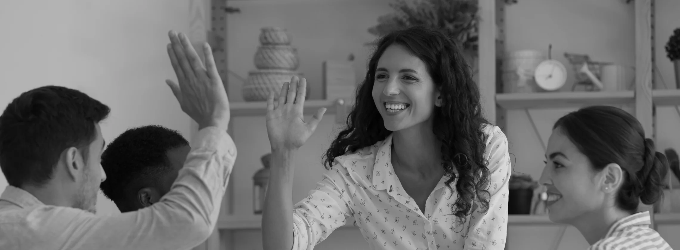 woman and man high-fiving each other during workplace meeting